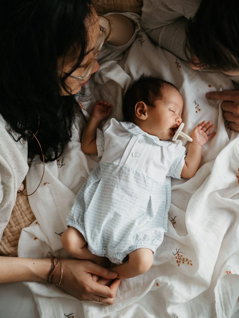 tendre moment entre maman et bébé qui dort lors d'une séance photo nouveau-né à domicile à Marseille