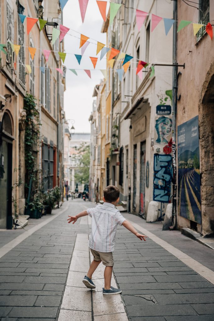 a little guy in the street of Le Panier during a vacation family photoshoot in Marseille, France