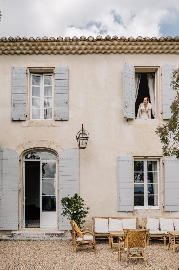 mariée à la fenêtre du domaine du Vallon des Sources à L’Isle-sur-la-Sorgue pendant un mariage