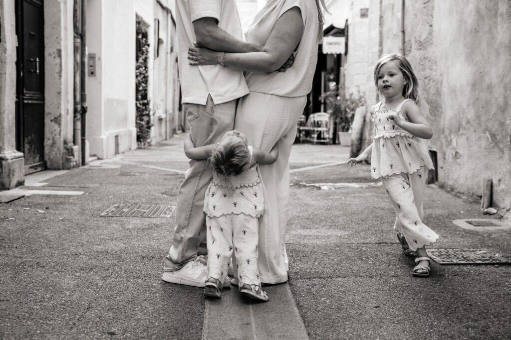 Une famille joue dans les ruelles tranquilles d'Aix-en-Provence lors d'un shooting photo en famille