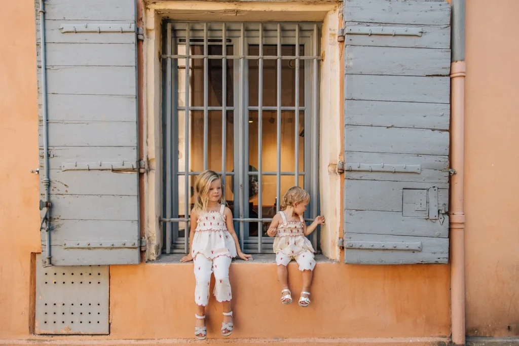 deux soeurs contre un mur coloré lors d'un reportage photo famille à Aix-en-Provence