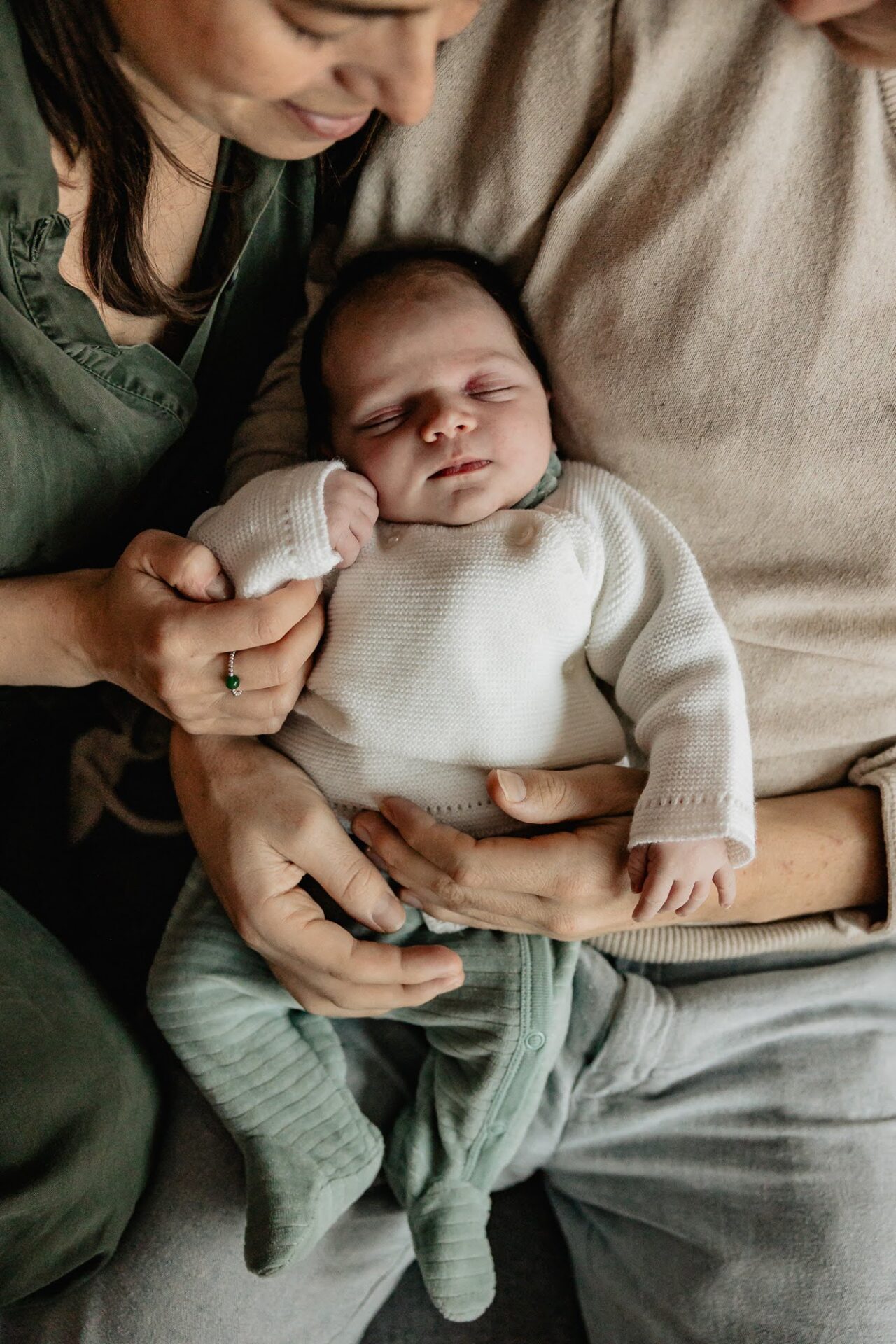 portrait de bébé dans les bras de ses parents lors d'une shooting photo à domicile à Marseille 13006