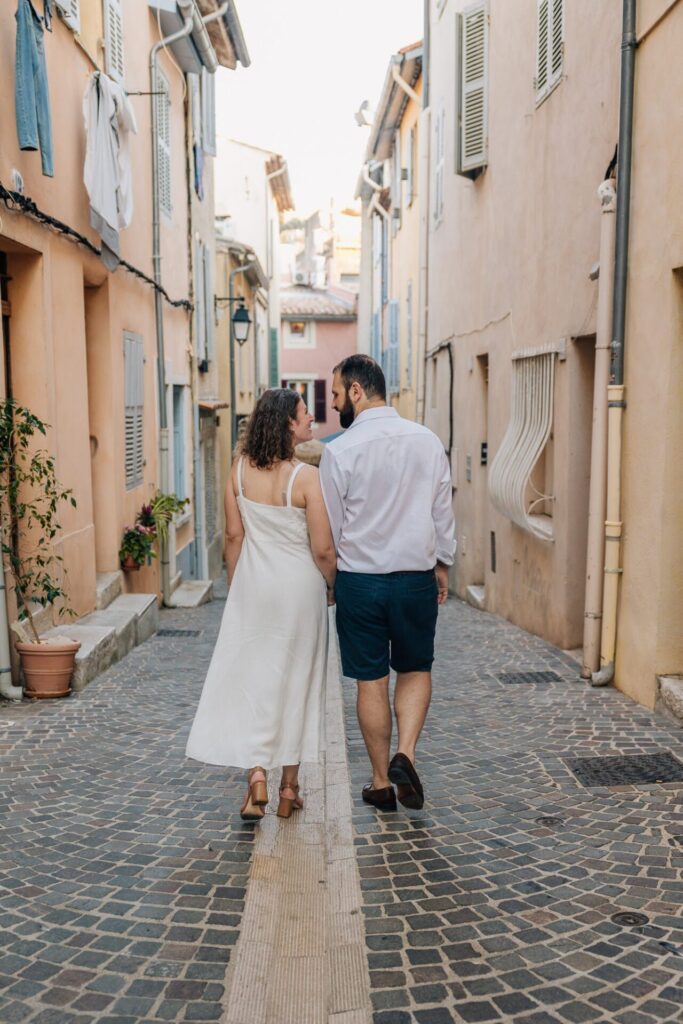 Photographe à Cassis – couple marchant dans une ruelle pavée du centre