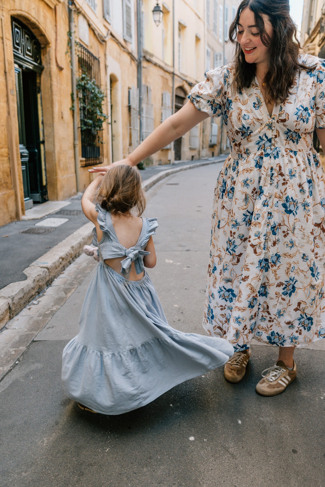 maman faisant tourner sa fille dans une rue d’Aix-en-Provence